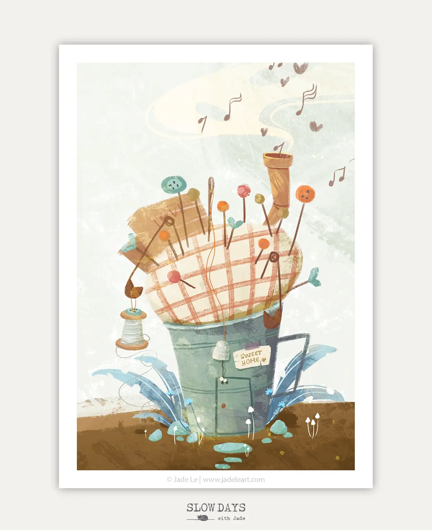 A digital preview of a charming art print depicting a rustic metal bucket converted into a house, filled with a plaid pincushion roof sprouting colorful pins and needles. A tiny "Sweet Home" sign hangs near the door, and musical notes float up from the chimney into a soft cream sky.