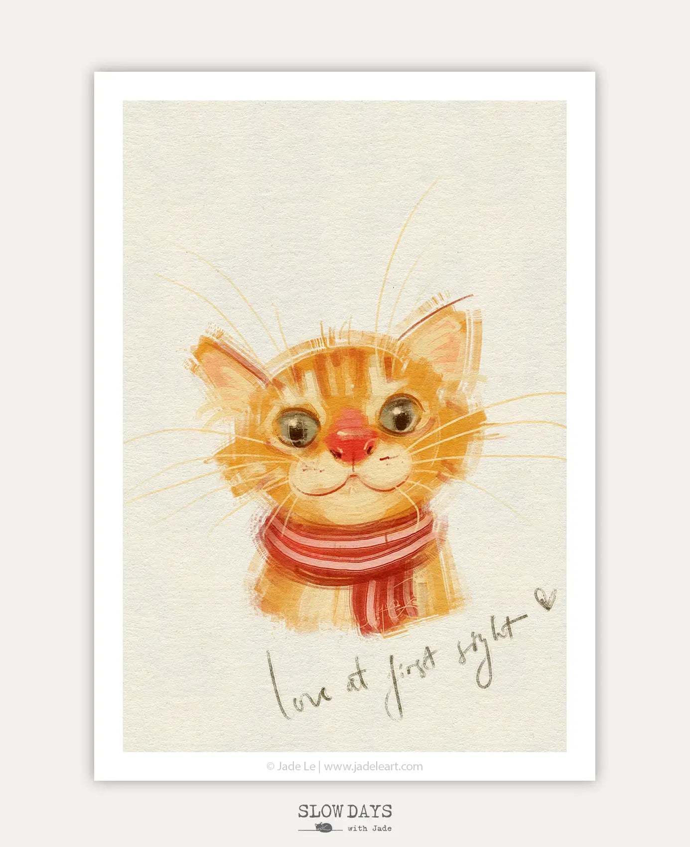 A digital preview of a heartwarming art print featuring a close-up portrait of a wide-eyed orange tabby cat wearing a red and pink striped scarf. The textured, painterly portrait is set against a cream background with the handwritten phrase "love at first sight" below it.